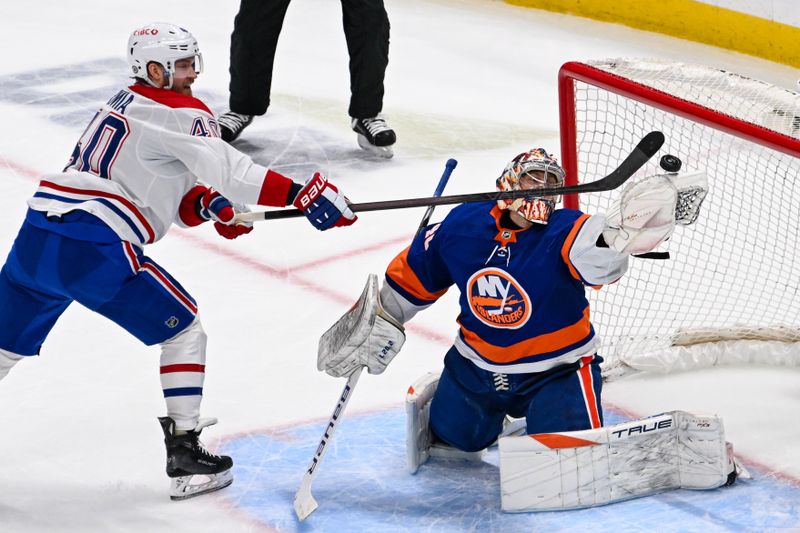 Apr 11, 2024; Elmont, New York, USA; New York Islanders goaltender Semyon Varlamov (40) makes a save on Montreal Canadiens right wing Joel Armia (40) during the second period at UBS Arena. Mandatory Credit: Dennis Schneidler-USA TODAY Sports