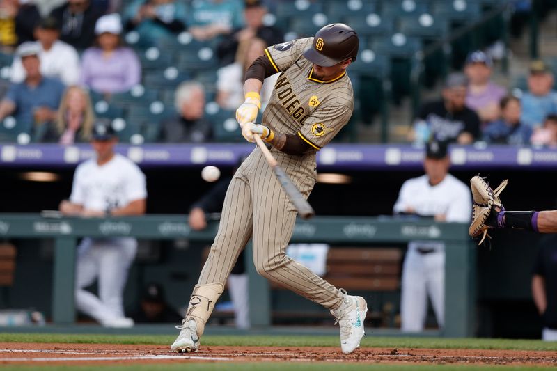 Apr 24, 2024; Denver, Colorado, USA; San Diego Padres center fielder Jackson Merrill (3) hits a sacrifice fly RBI in the first inning against the Colorado Rockies at Coors Field. Mandatory Credit: Isaiah J. Downing-USA TODAY Sports