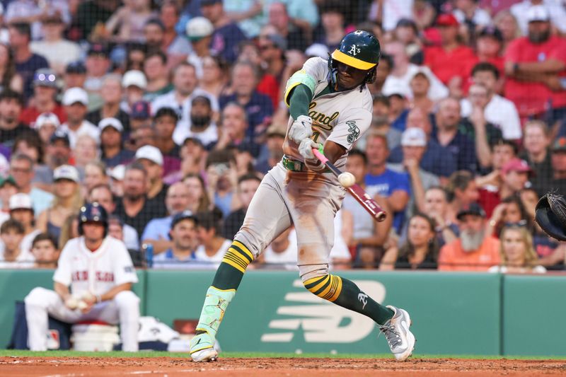 Jul 10, 2024; Boston, Massachusetts, USA; Oakland Athletics right fielder Lawrence Butler (4) hits a two run RBI double during the second inning against the Boston Red Sox at Fenway Park. Mandatory Credit: Paul Rutherford-USA TODAY Sports