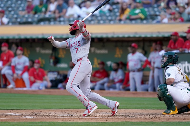 Jul 19, 2024; Oakland, California, USA; Los Angeles Angels right fielder Jo Adell (7) hits an RBI single against the Oakland Athletics in the second inning at Oakland-Alameda County Coliseum. Mandatory Credit: Cary Edmondson-USA TODAY Sports