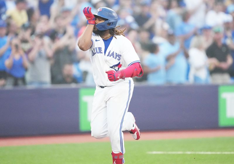 Jun 29, 2023; Toronto, Ontario, CAN; Toronto Blue Jays designated hitter Vladimir Guerrero Jr. (27) celebrates as he runs the bases after hitting a two run home run against the San Francisco Giants during the sixth inning at Rogers Centre. Mandatory Credit: Nick Turchiaro-USA TODAY Sports