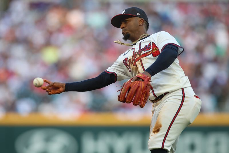 May 30, 2024; Atlanta, Georgia, USA; Atlanta Braves second baseman Ozzie Albies (1) throws a runner out at first against the Washington Nationals in the third inning at Truist Park. Mandatory Credit: Brett Davis-USA TODAY Sports
