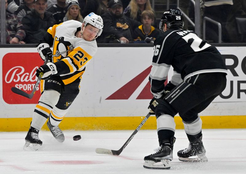 Feb 11, 2023; Los Angeles, California, USA;  Pittsburgh Penguins left wing Brock McGinn (23)  shoots the puck against Los Angeles Kings defenseman Sean Walker (26) in the first period at Crypto.com Arena. Mandatory Credit: Jayne Kamin-Oncea-USA TODAY Sports