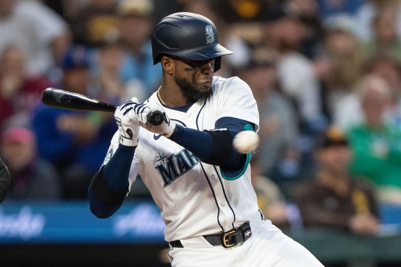 Sep 11, 2024; Seattle, Washington, USA;  Seattle Mariners right fielder Victor Robles (10) is hit by a pitch during the third inning against the San Diego Padres at T-Mobile Park. Mandatory Credit: Stephen Brashear-Imagn Images