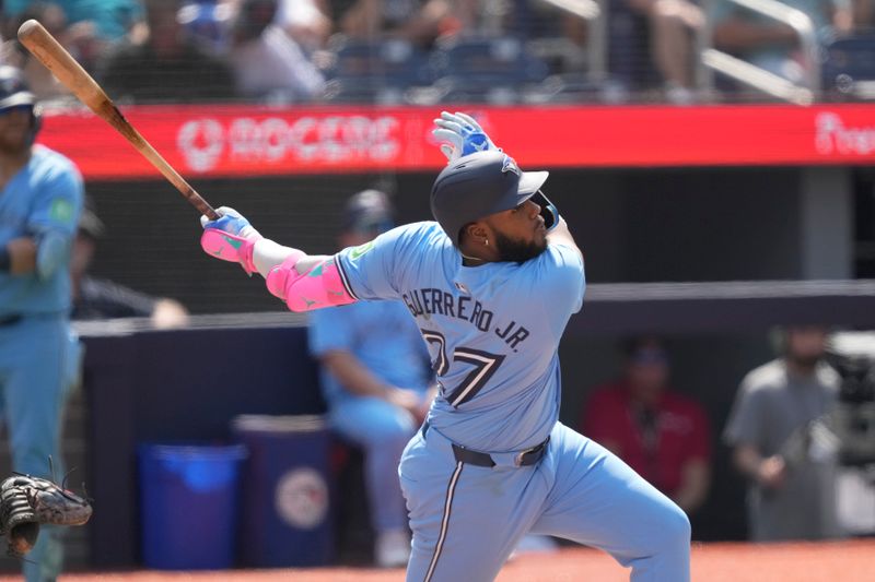 Jul 21, 2024; Toronto, Ontario, CAN; Toronto Blue Jays designated hitter Vladimir Guerrero Jr. (27) hits a double against the Detroit Tigers during the seventh inning at Rogers Centre. Mandatory Credit: John E. Sokolowski-USA TODAY Sports