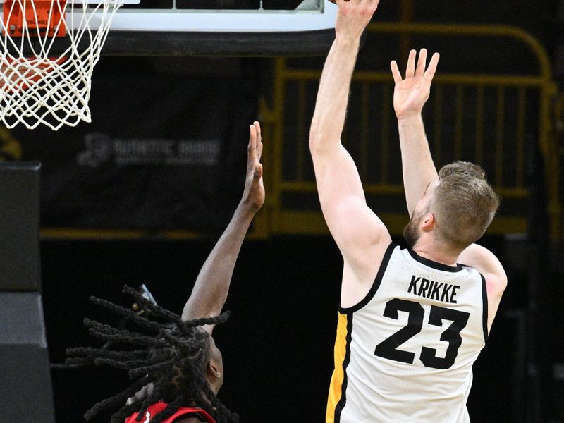 Jan 6, 2024; Iowa City, Iowa, USA; Iowa Hawkeyes forward Ben Krikke (23) shoots the ball over Rutgers Scarlet Knights center Clifford Omoruyi (11) during the first half at Carver-Hawkeye Arena. Mandatory Credit: Jeffrey Becker-USA TODAY Sports