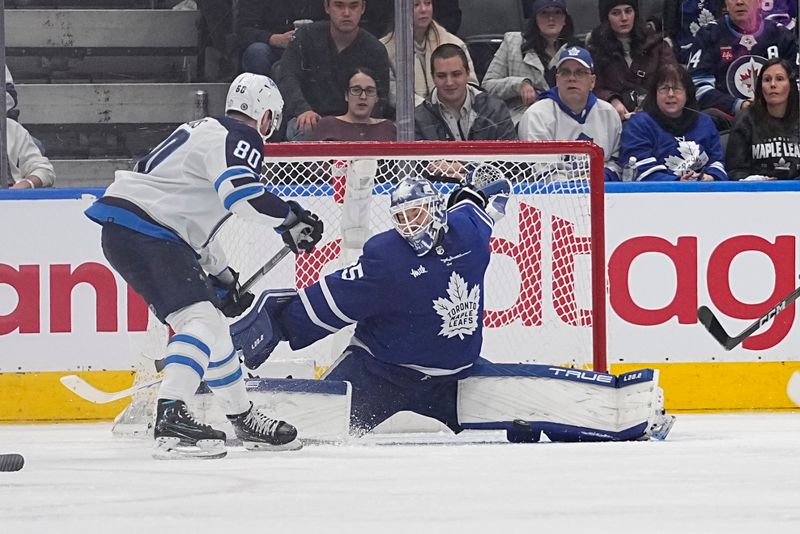 Jan 19, 2023; Toronto, Ontario, CAN; Toronto Maple Leafs goaltender Ilya Samsonov (35) makes a save against Winnipeg Jets forward Pierre-Luc Dubois (80) during the third period at Scotiabank Arena. Mandatory Credit: John E. Sokolowski-USA TODAY Sports