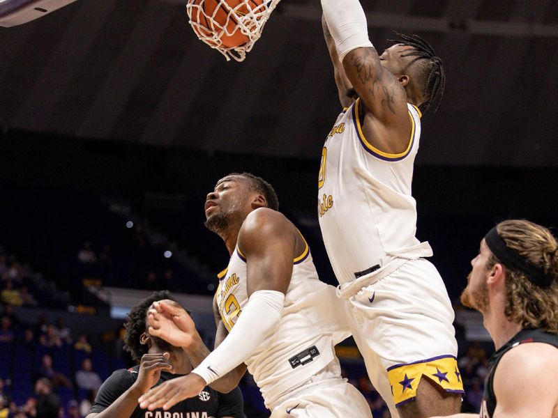 Feb 18, 2023; Baton Rouge, Louisiana, USA; LSU Tigers guard Trae Hannibal (0) tips the ball in against South Carolina Gamecocks forward Josh Gray (33) at Pete Maravich Assembly Center. Mandatory Credit: Stephen Lew-USA TODAY Sports