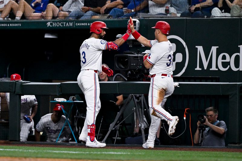 Aug 5, 2024; Arlington, Texas, USA; Texas Rangers center fielder Leody Taveras (3) and first baseman Nathaniel Lowe (30) celebrate Lowe scoring a run against the Houston Astros during the fifth inning at Globe Life Field. Mandatory Credit: Jerome Miron-USA TODAY Sports