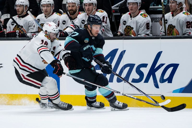 Jan 24, 2024; Seattle, Washington, USA; Seattle Kraken forward Jaden Schwartz (17) battles Chicago Blackhawks forward Jason Dickinson (16) for the puck during the second period at Climate Pledge Arena. Mandatory Credit: Stephen Brashear-USA TODAY Sports