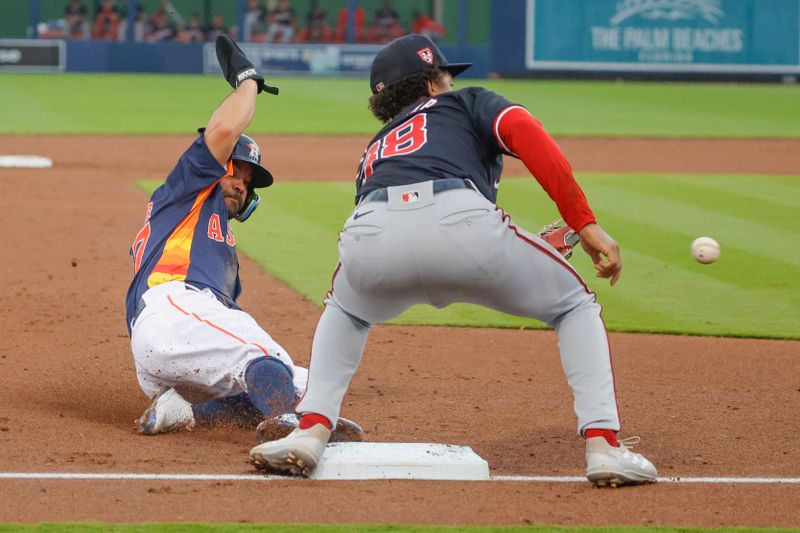 Mar 18, 2024; West Palm Beach, Florida, USA;  Houston Astros second baseman Jose Altuve (27) slides safely into third base as Washington Nationals third baseman Trey Lipscomb (38) waits on the ball to arrive during the third inning at The Ballpark of the Palm Beaches. Mandatory Credit: Reinhold Matay-USA TODAY Sports