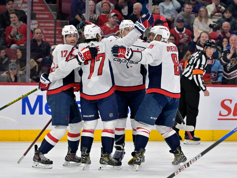 Feb 17, 2024; Montreal, Quebec, CAN; Washington Capitals forward T.J. Oshie (77) celebrates with teammates including forward Alex Ovechkin (8)after scoring a goal against the Montreal Canadiens during the first period at the Bell Centre. Mandatory Credit: Eric Bolte-USA TODAY Sports