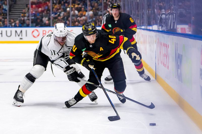 Mar 25, 2024; Vancouver, British Columbia, CAN; Los Angeles Kings forward Anze Kopitar (11) checks Vancouver Canucks forward Elias Pettersson (40) in the third period at Rogers Arena. Kings won 3 -2. Mandatory Credit: Bob Frid-USA TODAY Sports