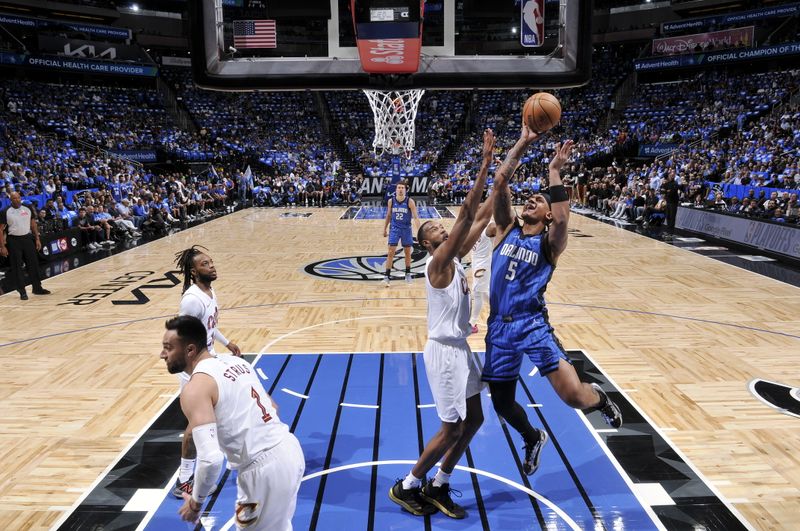 ORLANDO, FL - APRIL 27: Paolo Banchero #5 of the Orlando Magic shoots the ball during the game against the Cleveland Cavaliers during Round 1 Game 4 of the 2024 NBA Playoffs on April 27, 2024 at the Kia Center in Orlando, Florida. NOTE TO USER: User expressly acknowledges and agrees that, by downloading and or using this photograph, User is consenting to the terms and conditions of the Getty Images License Agreement. Mandatory Copyright Notice: Copyright 2024 NBAE (Photo by Fernando Medina/NBAE via Getty Images)