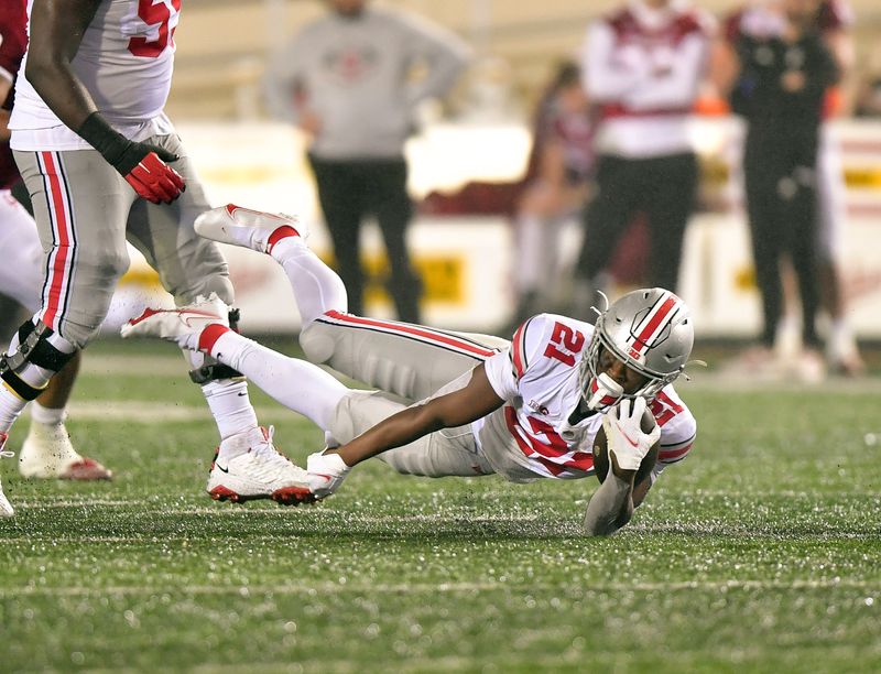 Oct 23, 2021; Bloomington, Indiana, USA; Ohio State Buckeyes running back Evan Pryor (21) dives with the ball against the Indiana Hoosiers during the second half at Memorial Stadium. Ohio State won 54-7. Mandatory Credit: Marc Lebryk-USA TODAY Sports