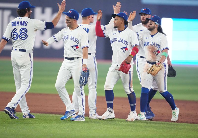 Jun 29, 2023; Toronto, Ontario, CAN; Toronto Blue Jays relief pitcher Jordan Romano (68) celebrates the win with Toronto Blue Jays left fielder Whit Merrifield (15)  against the San Francisco Giants at the end of the ninth inning at Rogers Centre. Mandatory Credit: Nick Turchiaro-USA TODAY Sports