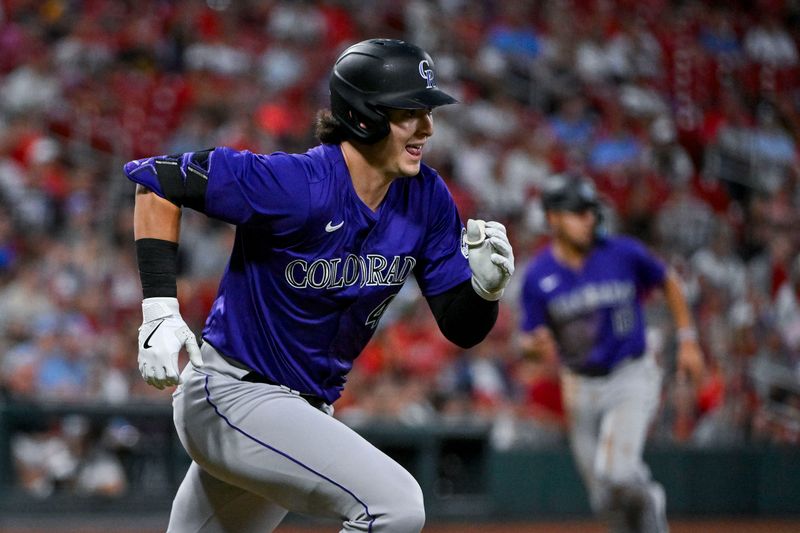 Jun 7, 2024; St. Louis, Missouri, USA;  Colorado Rockies right fielder Michael Toglia (4) runs down the first base line after hitting a three run triple against the St. Louis Cardinals during the fourth inning at Busch Stadium. Mandatory Credit: Jeff Curry-USA TODAY Sports