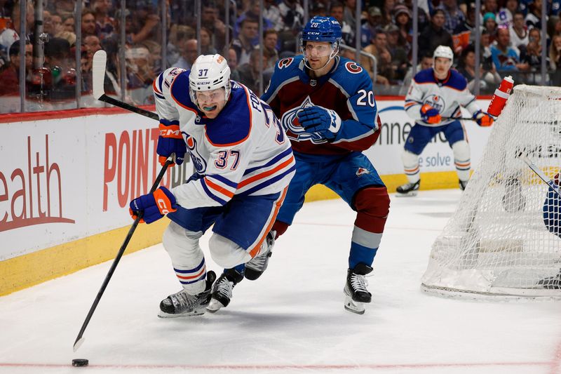 Apr 11, 2023; Denver, Colorado, USA; Edmonton Oilers left wing Warren Foegele (37) controls the puck ahead of Colorado Avalanche center Lars Eller (20) in the third period at Ball Arena. Mandatory Credit: Isaiah J. Downing-USA TODAY Sports