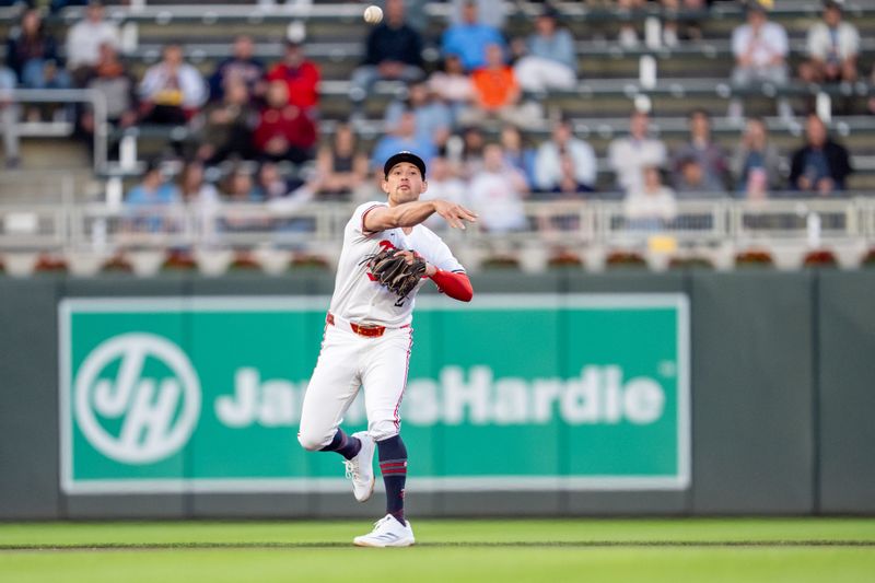 Apr 23, 2025; Minneapolis, Minnesota, USA; Minnesota Twins third base Brooks Lee (2) throws out Chicago White Sox designated hitter Edgar Quero (7) in the fourth inning at Target Field. Mandatory Credit: Matt Blewett-Imagn Images