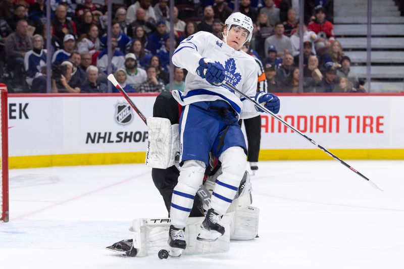 Feb 10, 2024; Ottawa, Ontario, CAN; Toronto Maple Leafs left wing Matthew Knies (23) collides with Ottawa Senators goalie Joonas Korpisalo (70) in the second period at the Canadian Tire Centre. Mandatory Credit: Marc DesRosiers-USA TODAY Sports