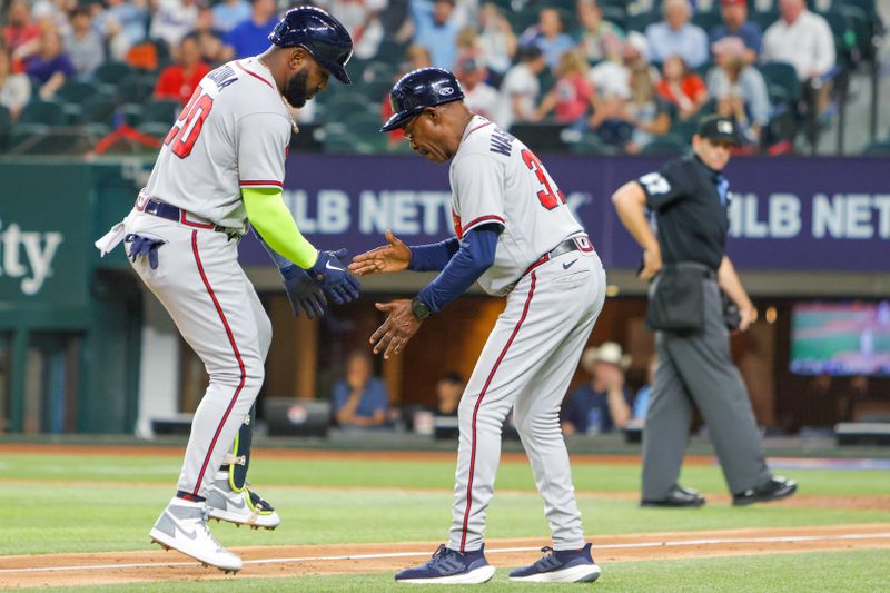 May 15, 2023; Arlington, Texas, USA; Atlanta Braves designated hitter Marcell Ozuna (20) slaps hands with third base coach Ron Washington (37) after hitting a two-run home run during the ninth inning against the Texas Rangers at Globe Life Field. Mandatory Credit: Andrew Dieb-USA TODAY Sports