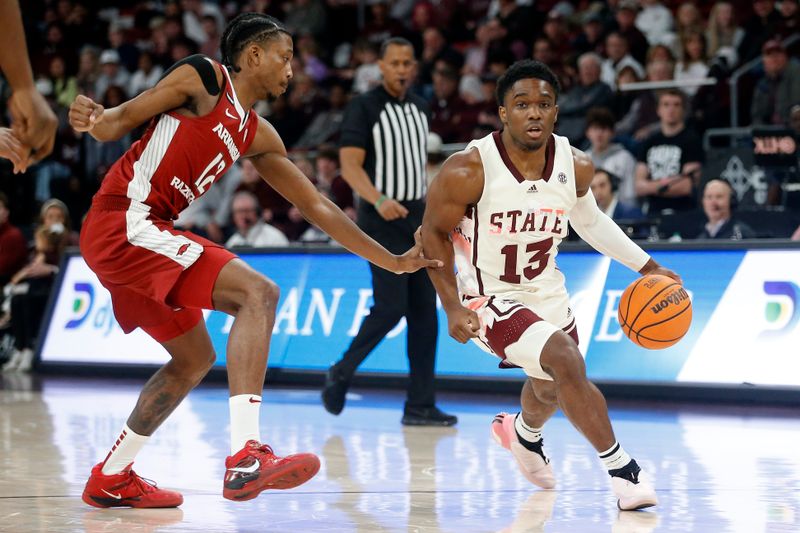 Feb 17, 2024; Starkville, Mississippi, USA; Mississippi State Bulldogs guard Josh Hubbard (13) drives to the basket against Arkansas Razorbacks guard Tramon Mark (12) during the first half at Humphrey Coliseum. Mandatory Credit: Petre Thomas-USA TODAY Sports