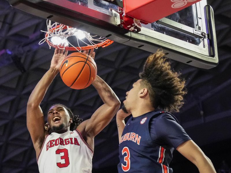 Jan 4, 2023; Athens, Georgia, USA; Georgia Bulldogs guard Kario Oquendo (3) dunks against Auburn Tigers guard Tre Donaldson (3) during the second half at Stegeman Coliseum. Mandatory Credit: Dale Zanine-USA TODAY Sports