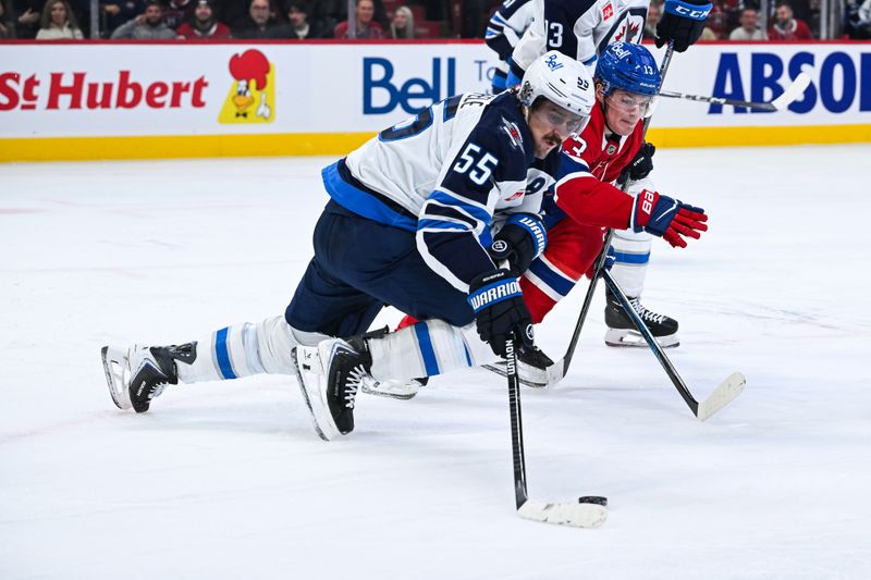 Dec 3, 2025; Montreal, Quebec, CAN; Winnipeg Jets center Mark Scheifele (55) defends the puck against Montreal Canadiens right wing Cole Caufield (13) during the first period at Bell Centre. Mandatory Credit: David Kirouac-Imagn Images