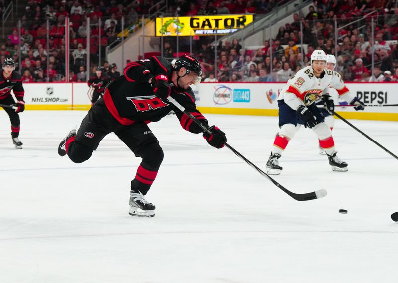 Mar 14, 2024; Raleigh, North Carolina, USA; Carolina Hurricanes center Evgeny Kuznetsov (92) takes a shot against the Florida Panthers during the third period at PNC Arena. Mandatory Credit: James Guillory-USA TODAY Sports