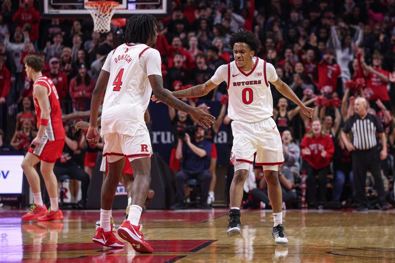 Jan 2, 2026; Piscataway, New Jersey, USA; Rutgers Scarlet Knights guard Tariq Francis (0) celebrates with forward Bryce Dortch (4) after a basket against the Ohio State Buckeyes during the first half at Jersey Mike's Arena. Mandatory Credit: Vincent Carchietta-Imagn Images