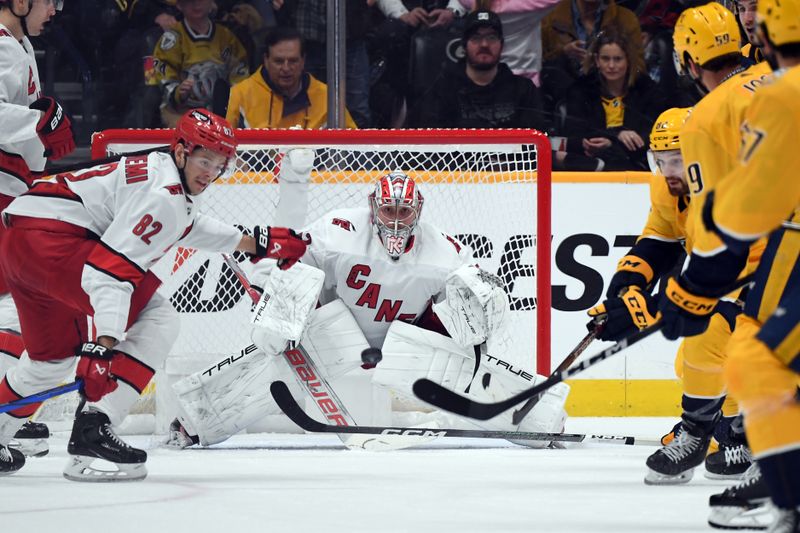 Dec 27, 2023; Nashville, Tennessee, USA; Carolina Hurricanes goaltender Pyotr Kochetkov (52) watches the puck after a save during the second period against the Nashville Predators at Bridgestone Arena. Mandatory Credit: Christopher Hanewinckel-USA TODAY Sports