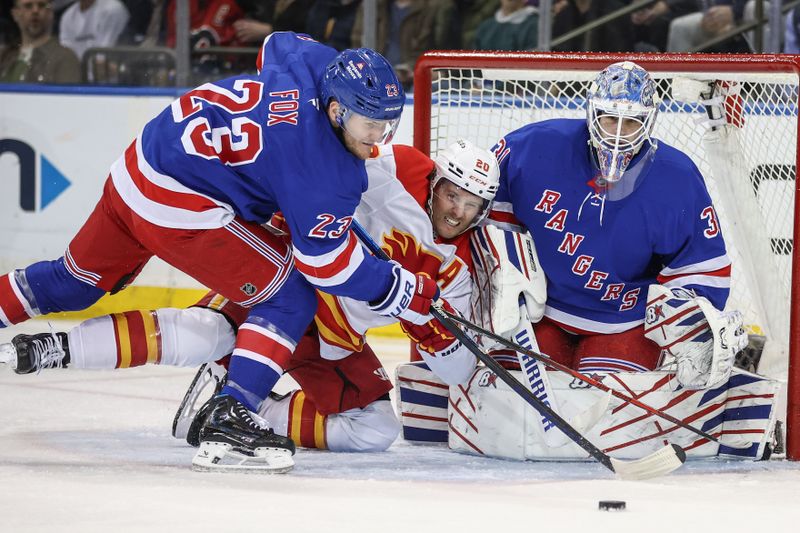 Mar 18, 2025; New York, New York, USA;  New York Rangers goaltender Igor Shesterkin (31) defends the net as  defenseman Adam Fox (23) and Calgary Flames left wing Blake Coleman (20) battle for control of the puck in the second period at Madison Square Garden. Mandatory Credit: Wendell Cruz-Imagn Images