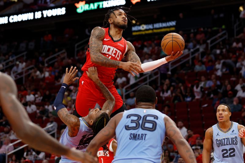 HOUSTON, TEXAS - OCTOBER 25: Cam Whitmore #7 of the Houston Rockets goes up for a shot while defended by Ja Morant #12 of the Memphis Grizzlies in the first half at Toyota Center on October 25, 2024 in Houston, Texas.  NOTE TO USER: User expressly acknowledges and agrees that, by downloading and or using this photograph, User is consenting to the terms and conditions of the Getty Images License Agreement.  (Photo by Tim Warner/Getty Images)