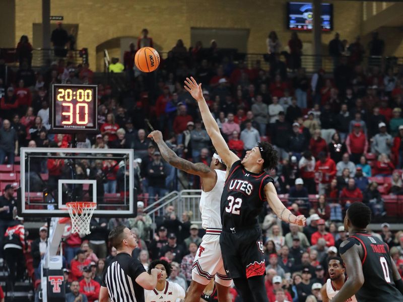 Jan 14, 2026; Lubbock, Texas, USA;  Texas Tech Red Raiders forward JT Toppin (15) and Utah Utes forward James Okonkwo (32) vie for the opening tip at United Supermarkets Arena. Mandatory Credit: Michael C. Johnson-Imagn Images