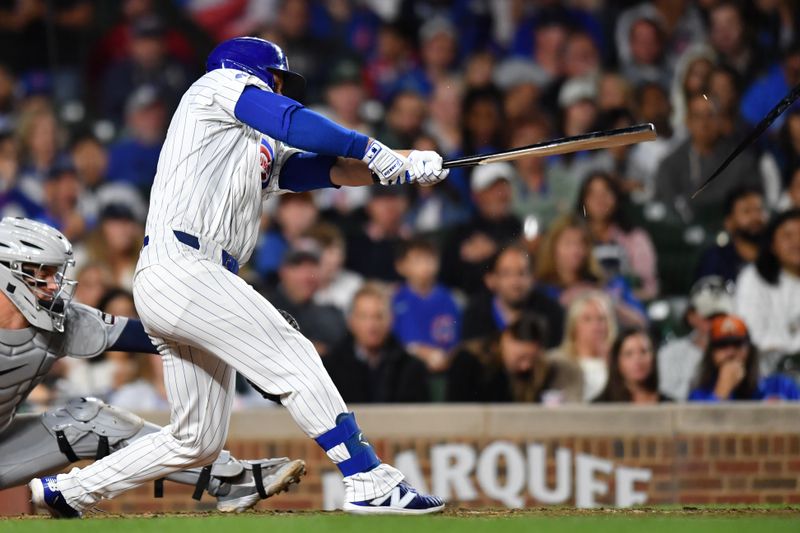 Aug 20, 2024; Chicago, Illinois, USA; Chicago Cubs first base Michael Busch (29) grounds out while breaking his bat during the seventh inning against the Detroit Tigers at Wrigley Field. Mandatory Credit: Patrick Gorski-USA TODAY Sports