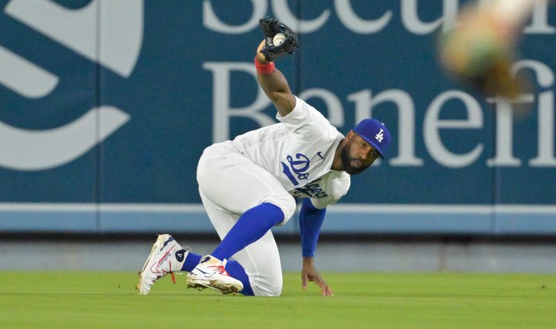 Aug 17, 2023; Los Angeles, California, USA;  Los Angeles Dodgers right fielder Jason Heyward (23) hangs on to fly ball of Milwaukee Brewers left fielder Christian Yelich (22) in the eighth inning at Dodger Stadium. Mandatory Credit: Jayne Kamin-Oncea-USA TODAY Sports