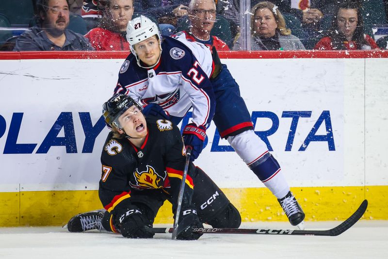 Jan 25, 2024; Calgary, Alberta, CAN; Columbus Blue Jackets defenseman Adam Boqvist (27) checks Calgary Flames center Connor Zary (47) during the first period at Scotiabank Saddledome. Mandatory Credit: Sergei Belski-USA TODAY Sports