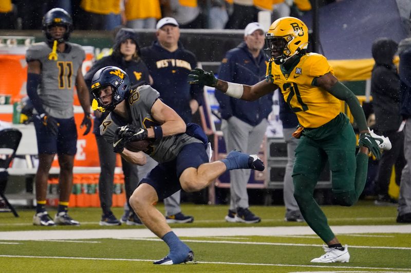 Nov 25, 2023; Waco, Texas, USA; West Virginia Mountaineers wide receiver Hudson Clement (84) makes the catch in front of Baylor Bears cornerback Chateau Reed (21) during the first half at McLane Stadium. Mandatory Credit: Raymond Carlin III-USA TODAY Sports