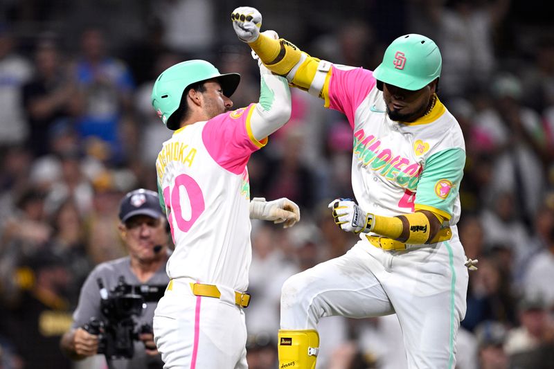 Jun 21, 2024; San Diego, California, USA; San Diego Padres first baseman Luis Arraez (4) celebrates with catcher Kyle Higashioka (20) after hitting a two-run home run against the Milwaukee Brewers during the fifth inning at Petco Park. Mandatory Credit: Orlando Ramirez-USA TODAY Sports