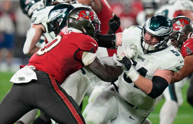 Tampa Bay Buccaneers linebacker Yaya Diaby (0) blocks Philadelphia Eagles center Cam Jurgens (51) during the second half of an NFL wild-card football game Monday, Jan. 15, 2024, in Tampa, Fla. (AP Photo/Chris O'Meara)