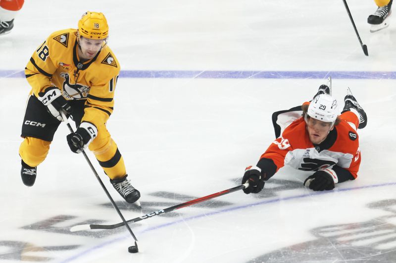 Jan 15, 2026; Pittsburgh, Pennsylvania, USA;  Pittsburgh Penguins center Tommy Novak (18) moves the puck against Philadelphia Flyers right wing Nikita Grebenkin (29) during the second period at PPG Paints Arena. Mandatory Credit: Charles LeClaire-Imagn Images