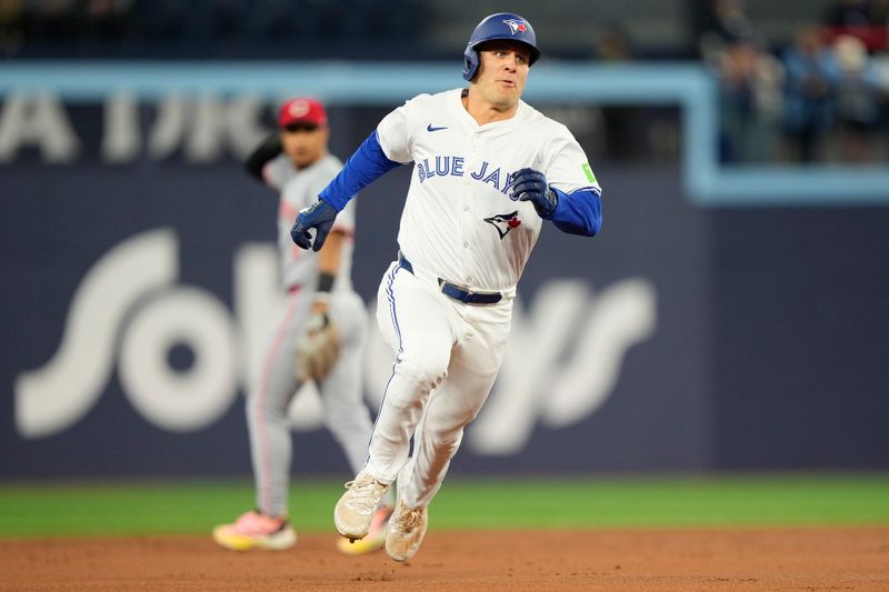 Aug 20, 2024; Toronto, Ontario, CAN; Toronto Blue Jays center fielder Daulton Varsho (25) runs to third base on his triple against the Cincinnati Reds during the first inning at Rogers Centre. Mandatory Credit: John E. Sokolowski-USA TODAY Sports