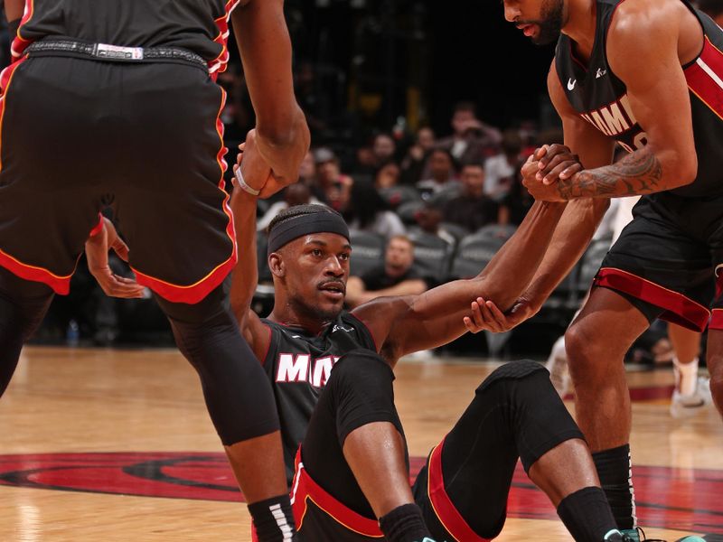 MIAMI, FL - MARCH 24: Jimmy Butler #22 of the Miami Heat is helped up during the game against the Cleveland Cavaliers on March 24, 2024 at Kaseya Center in Miami, Florida. NOTE TO USER: User expressly acknowledges and agrees that, by downloading and or using this Photograph, user is consenting to the terms and conditions of the Getty Images License Agreement. Mandatory Copyright Notice: Copyright 2024 NBAE (Photo by Issac Baldizon/NBAE via Getty Images)