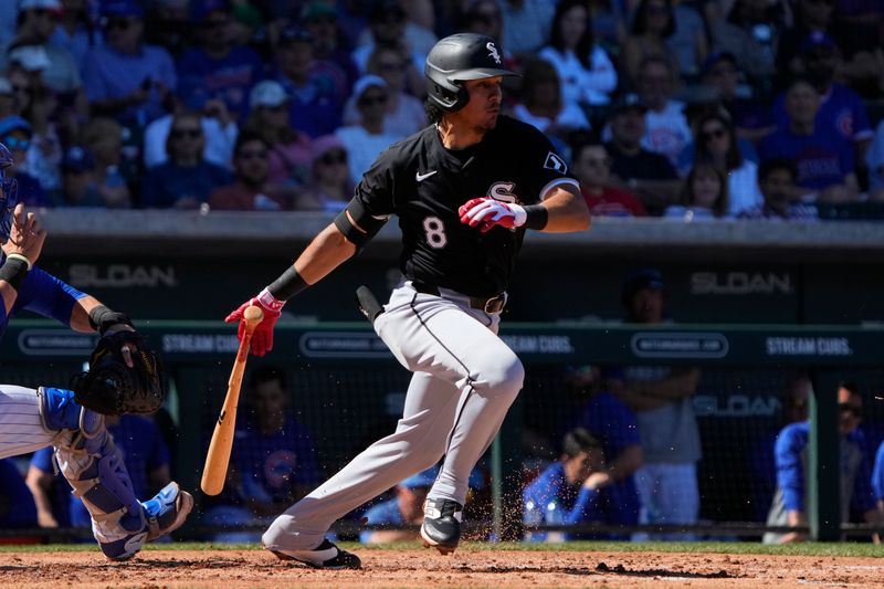 Mar 1, 2024; Mesa, Arizona, USA; Chicago White Sox second baseman Nicky Lopez (8) hits a single against the Chicago Cubs during the third inning at Sloan Park. Mandatory Credit: Rick Scuteri-USA TODAY Sports