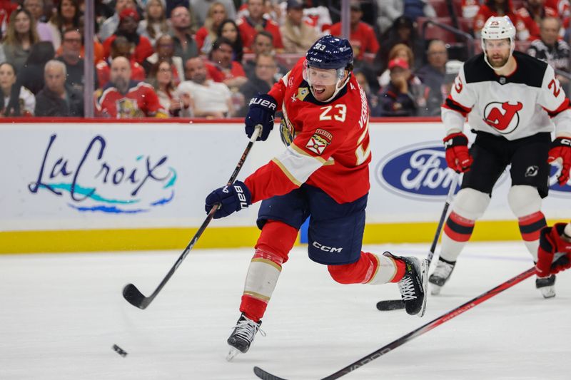 Nov 12, 2024; Sunrise, Florida, USA; Florida Panthers center Carter Verhaeghe (23) shoots the puck against the New Jersey Devils during the second period at Amerant Bank Arena. Mandatory Credit: Sam Navarro-Imagn Images