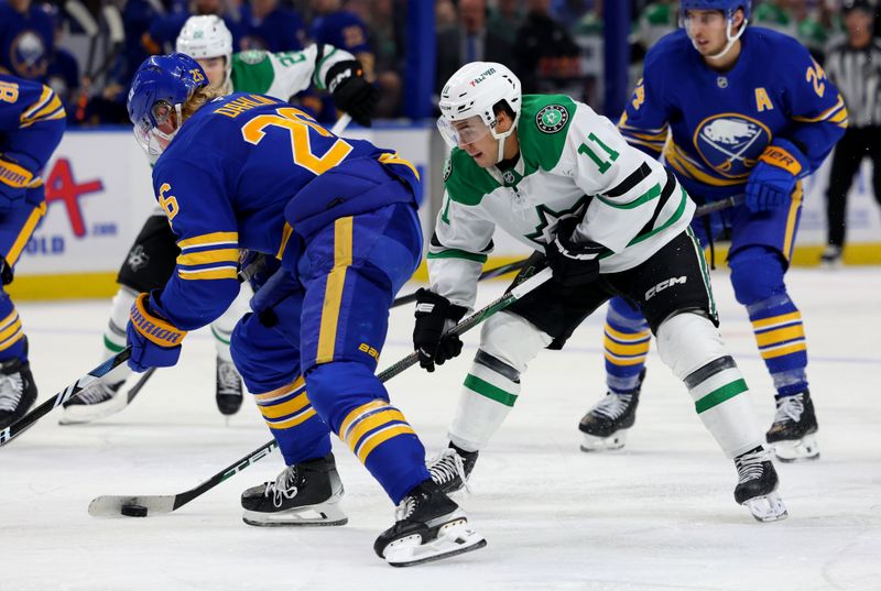 Oct 22, 2024; Buffalo, New York, USA;  Dallas Stars center Logan Stankoven (11) takes with the puck as Buffalo Sabres defenseman Rasmus Dahlin (26) defends during the third period at KeyBank Center. Mandatory Credit: Timothy T. Ludwig-Imagn Images