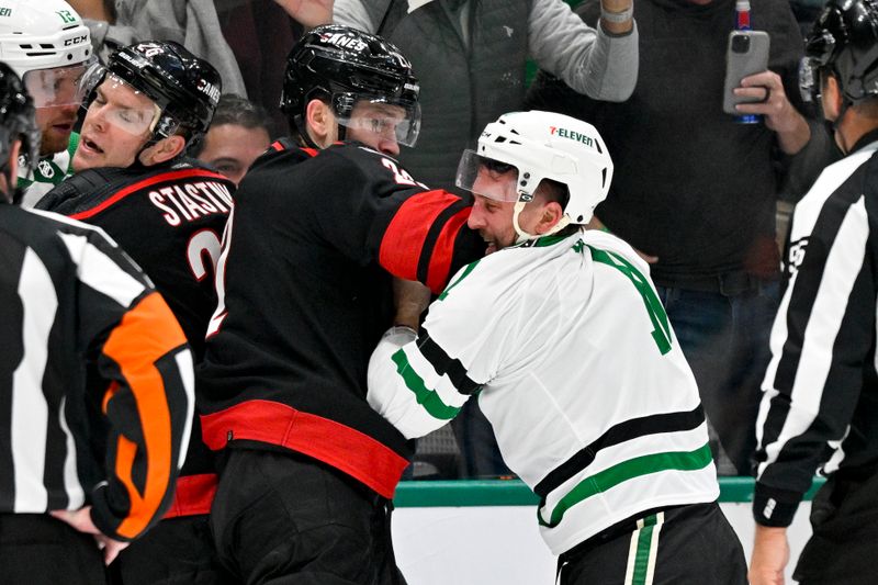 Jan 25, 2023; Dallas, Texas, USA; Carolina Hurricanes defenseman Brett Pesce (22) fights with Dallas Stars center Luke Glendening (11) during the second period at the American Airlines Center. Mandatory Credit: Jerome Miron-USA TODAY Sports