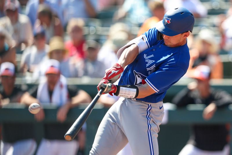 Mar 1, 2023; Sarasota, Florida, USA;  Toronto Blue Jays catcher Rob Brantly (55) hits an rbi double against the Baltimore Orioles in the fourth inning during spring training at  Ed Smith Stadium. Mandatory Credit: Nathan Ray Seebeck-USA TODAY Sports