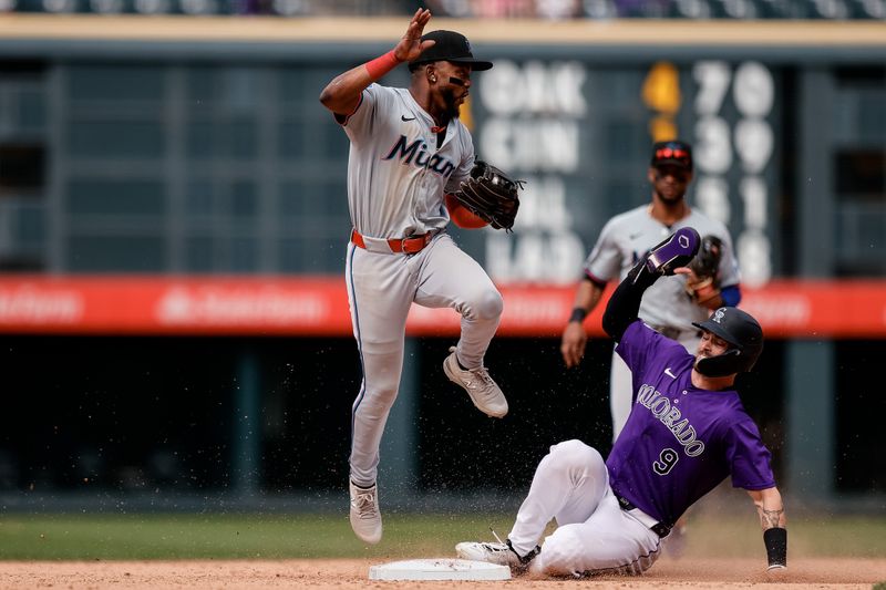Aug 29, 2024; Denver, Colorado, USA; Colorado Rockies center fielder Brenton Doyle (9) slides out into second base against Miami Marlins shortstop Vidal Brujan (17) in the ninth inning at Coors Field. Mandatory Credit: Isaiah J. Downing-USA TODAY Sports