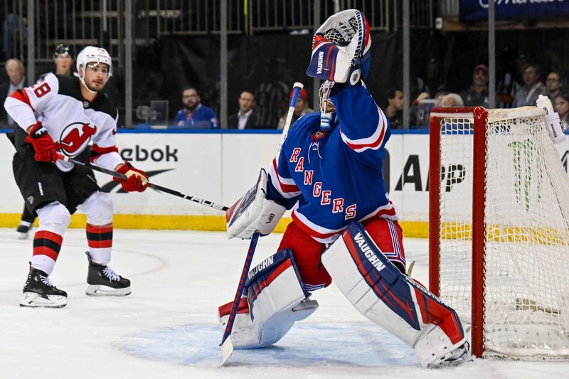 Oct 2, 2025; New York, New York, USA;  New York Rangers goaltender Jonathan Quick (32) makes a glove save against the New Jersey Devils during the first period at Madison Square Garden. Mandatory Credit: Dennis Schneidler-Imagn Images